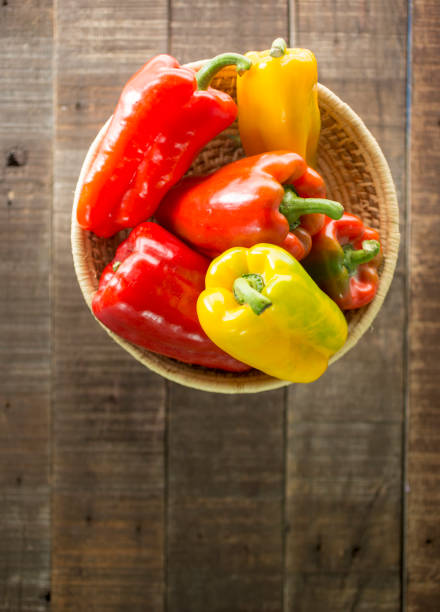 istock Sweet peppers in basket with wooden table 1165012038