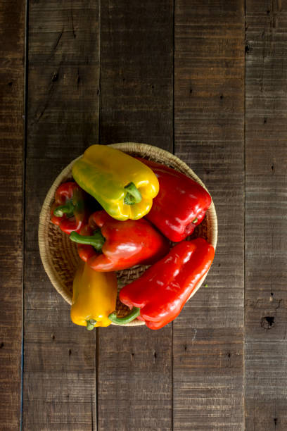 istock Sweet peppers in basket with wooden table 1165012058