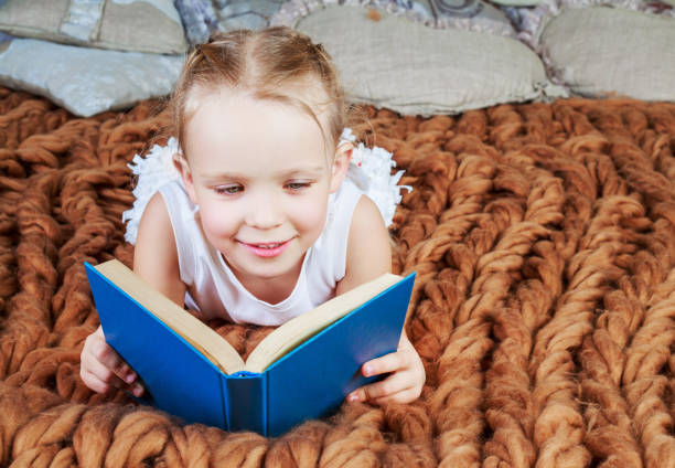istock girl reading in bed 1165012135