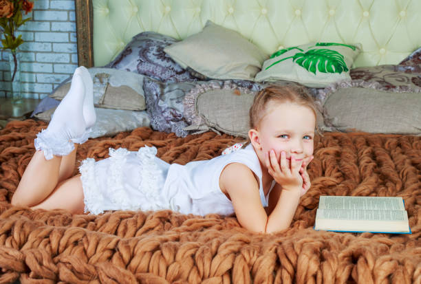 istock girl reading in bed 1165012856