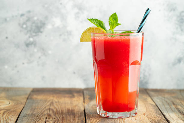 istock Watermelon slushie with lime and mint, summer refreshing drink in tall glasses on a light blue background. Sweet cold smoothie with copy space 1165012916
