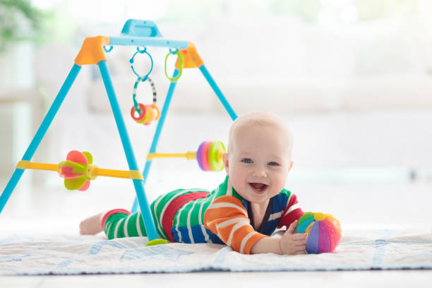 istock Baby boy with toys and ball 1165013162