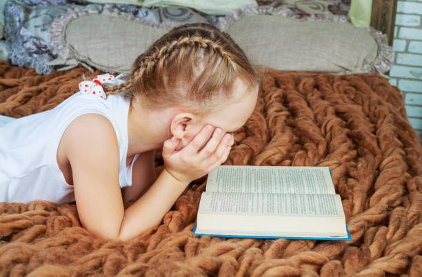 istock girl reading in bed 1165013972