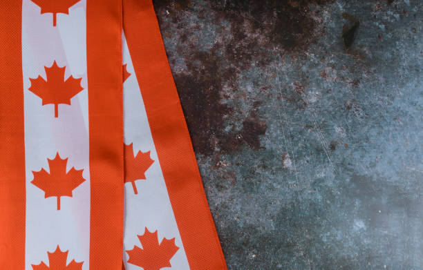 istock Canadian red and white flag against dark rustic background for Canada Day celebration and national holidays 1165017648