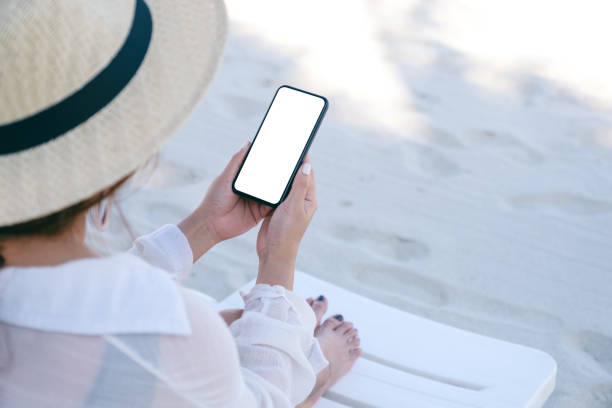 istock a woman holding black mobile phone with blank desktop screen 1165024046