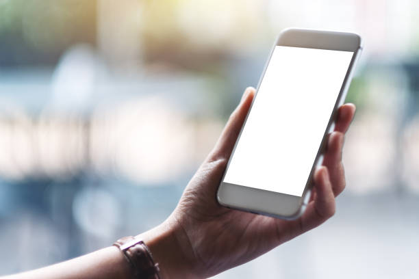 istock woman's hands holding white mobile phone with blank screen 1165024047