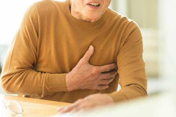 Senior man holding chest