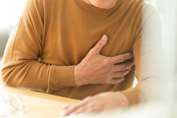 istock Senior man holding chest 1165024842