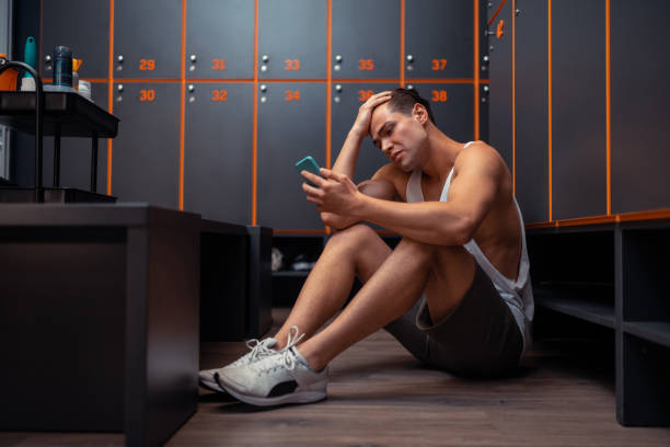 istock Unhappy cheerless man looking at his smartphone 1165025018