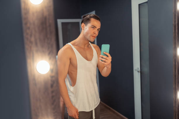 istock Nice attractive man taking a selfie in the mirror 1165025122
