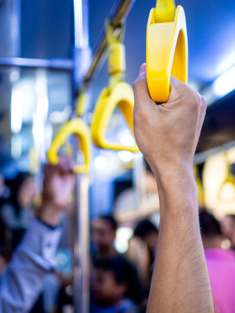 istock Close-up hand holding yellow handle in the bus. 1165025901