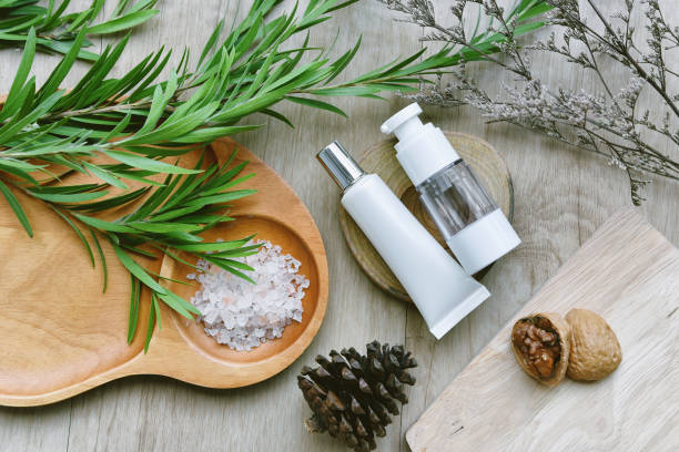istock Cosmetic bottle containers packaging with green herbal leaves, Blank label for organic branding mock-up, Natural skincare beauty product concept. 1165026652