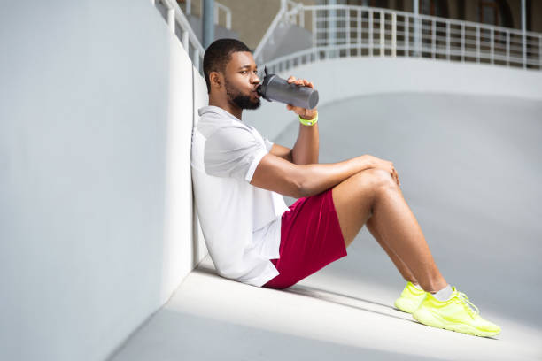 istock Calm young male athlete sitting at the stadium 1165026758
