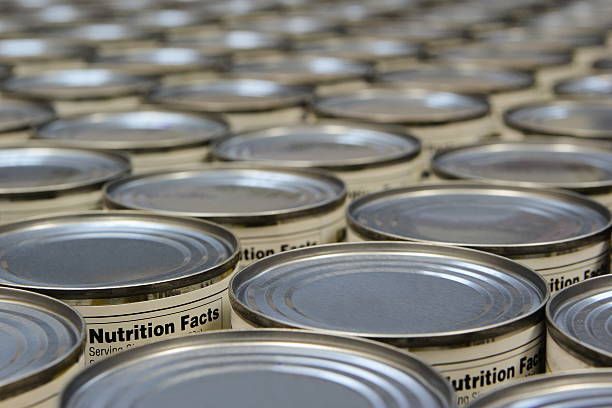A group of food cans with the nutrition fact label showing stock photo