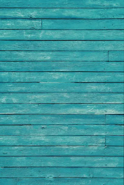 Photo of Old blue shabby wooden planks with cracked color paint