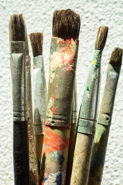 istock Old, Dirty Paint Brushes on white cement background, Close up & Macro shot, Selective focus, Stationery concept 1165035461