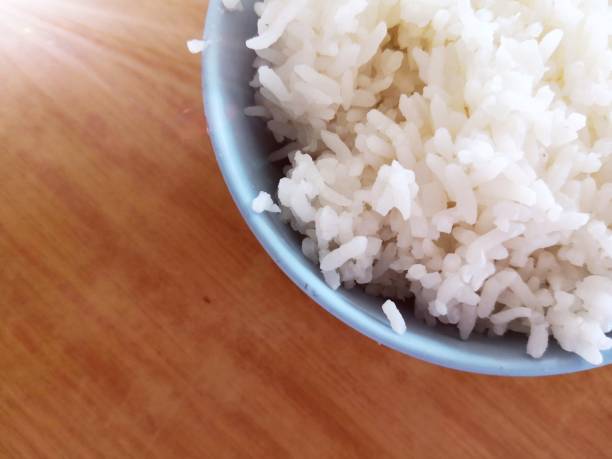 istock Bowl of rice on wooden table 1165035886