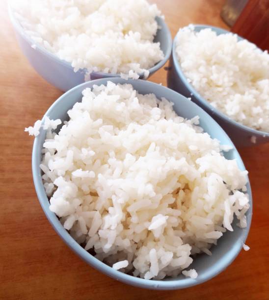 istock Bowl of rice on wooden table 1165035907
