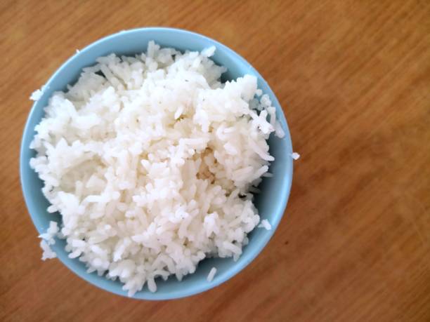 istock Bowl of rice on wooden table 1165035908