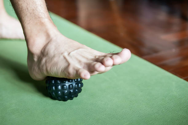 foot step on massage ball to relieve Plantar fasciitis or heel pain. foot step on massage ball to relieve Plantar fasciitis or heel pain. plantar fascia stock pictures, royalty-free photos & images