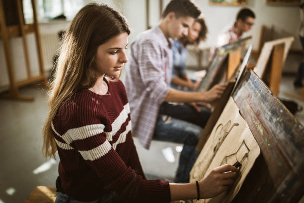 istock Female art student drawing a painting at art studio. 1165040344