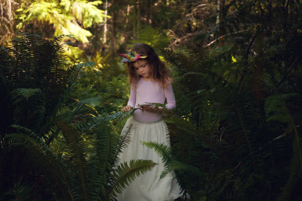 istock Little girl with ferns 1165040434