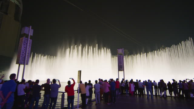 People enjoying the Dubai Fountain show at night