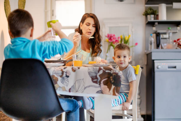 istock Mother cooling spaghetti on fork for her toddler 1165042213