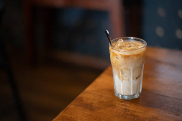 istock Delicious ice cold latte on wooden table without straw 1165043442