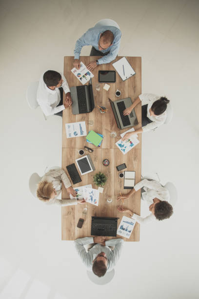 istock Overhead view of business meeting holding by multi-ethnic group 1165043482