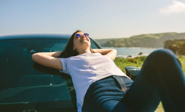 istock Young girl lying on the windshield 1165044316
