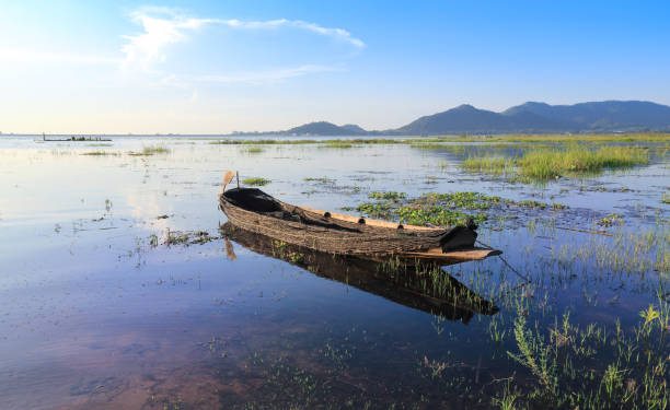 istock fishing boat with sunset in river 1165046611