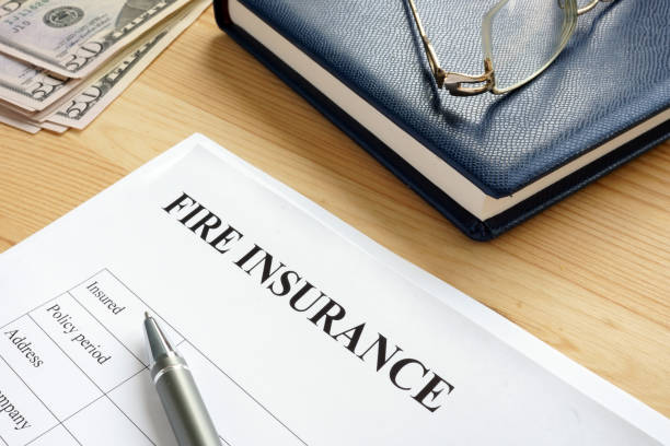 istock Fire insurance agreement with pen and money. 1165046758