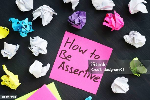 Memo Stick With Sign How To Be Assertive Stock Photo - Download Image Now - Assertiveness, Communication, Confidence