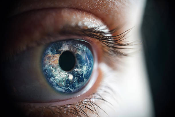 macro photo of the woman's eye and earth planet - eyesight vision imagens e fotografias de stock