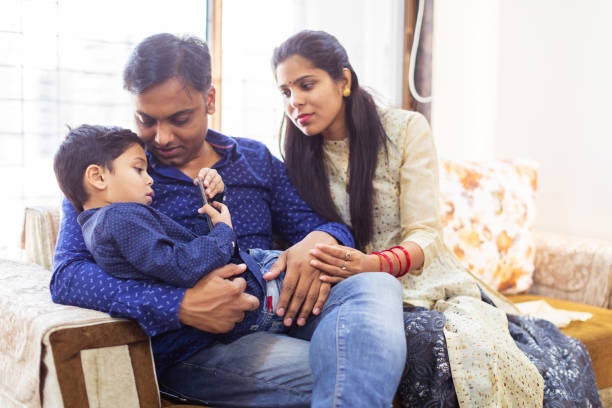 istock Kid Busy Playing on the smartphone while parents are trying to have a conversation 1165052056