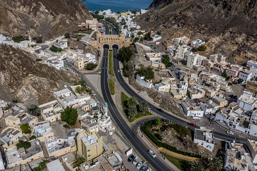 Two lanes of Al Bahri road passing below the Muscat Gate in Old Muscat, Oman.