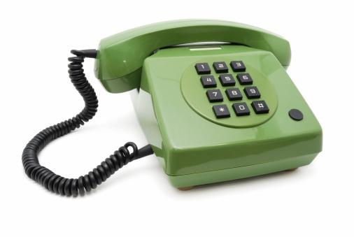 Old green phone on a white background. Made in GDR.1984