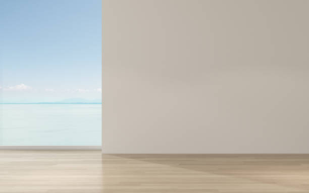 istock Perspective of empty modern living room on sea view background,The sun light cast shadow on the timber floor. - 3D rendering. 1165052496