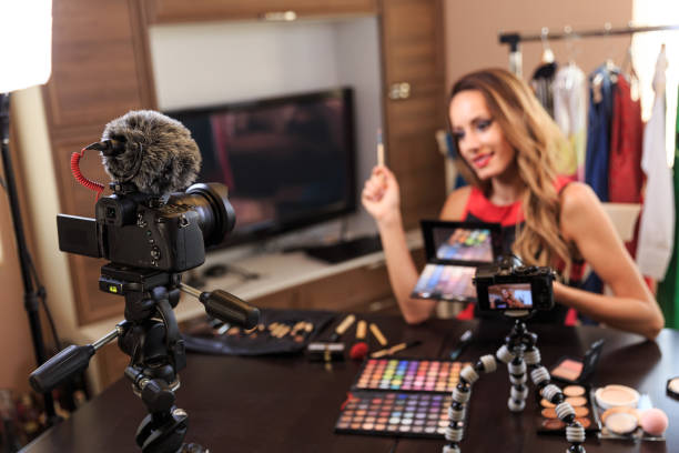 istock Female vlogger filming make-up video 1165054041