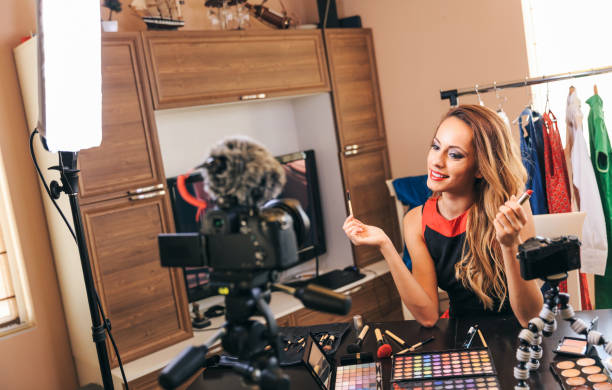 istock Female vlogger filming make-up video 1165054046