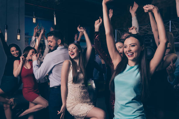 istock Nice-looking attractive lovely glamorous cheerful cheery positive elegant stylish diverse ladies and gentlemen having fun enjoying festal festive occasion in fashionable luxury nightclub indoors 1165054846