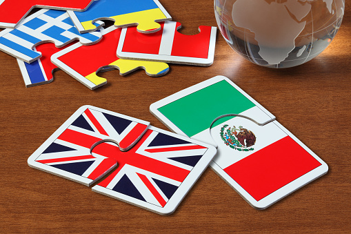 puzzle with the national flag of England and Mexican on wooden table