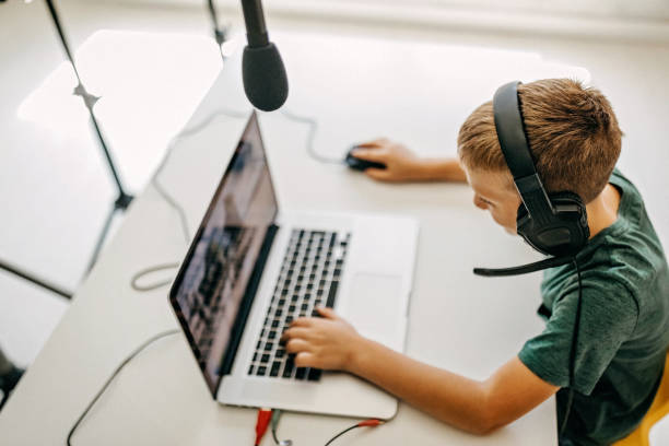 istock Kid recording his gameplay for vlog 1165059875