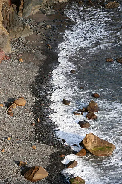 The Atlantic Ocean coming to land's end, Madeira Portugal in evening light.