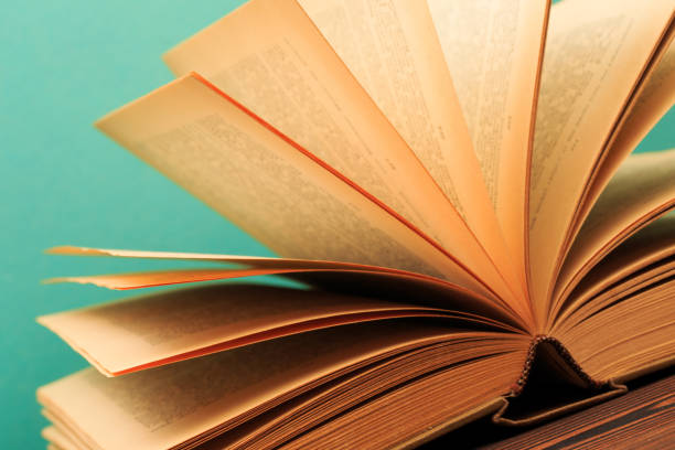 istock Open book on wooden vintage table blue background - Image 1165060913