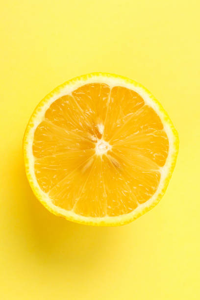 istock Top view of a one orange fruit slice on bright background in pastel color. 1165061576
