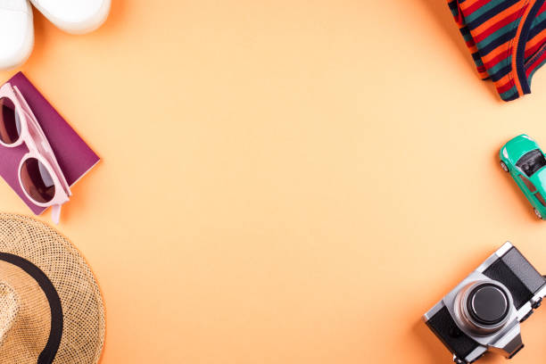 istock Travel items flat lay on orange with camera 1165062533