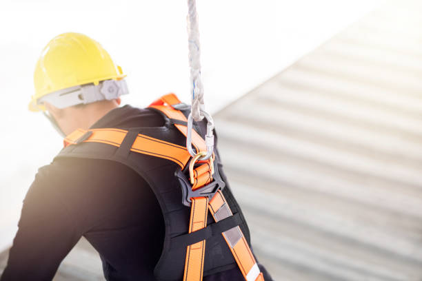 istock Industrial Worker with safety protective equipment loop hanging behind the back 1165062576
