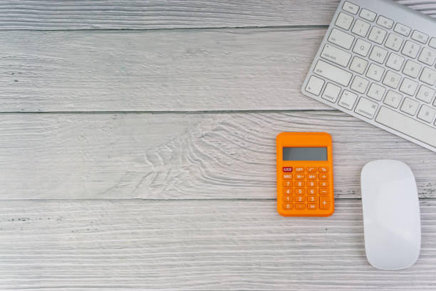 istock Workspace with mouse, calculator and keyboard on the wooden background 1165062908